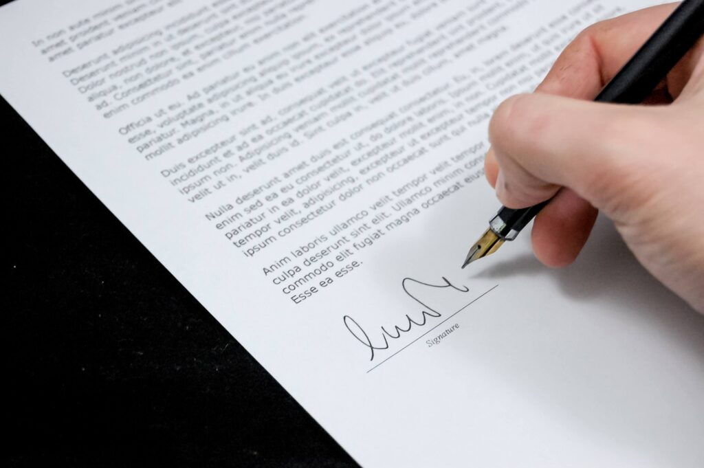 A person signing a legal document - lennon lawyers - estate planning lawyers